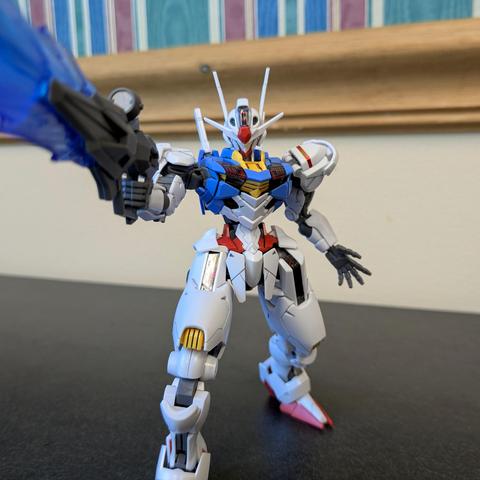 The HG Gundam Aerial lunging toward the viewer, appearing to attack with (what I guess is) a beam bayonet (at this point).
