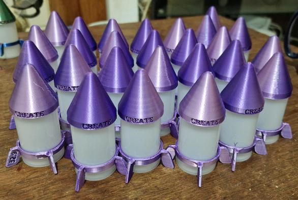 A fleet of purple film canister rockets
