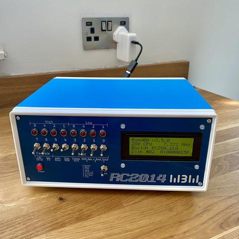 Photograph of a little blue box with switches lights and small LCD screen.