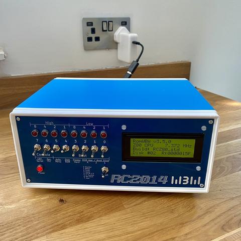 Photograph of a little blue box with switches lights and small LCD screen.