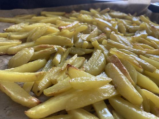 Oven tray with french fries from the side