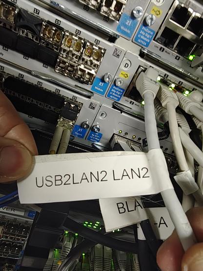 ethernet cable with a white label. The writing on the label is USB2LAN2LAN2