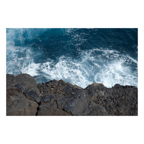 lava ledge above cerulean blue crashing waves in the pacific ocean