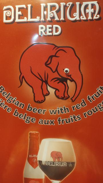 Cartoon elephant on a Belgian beer advert, which someone has stuck googly eyes onto