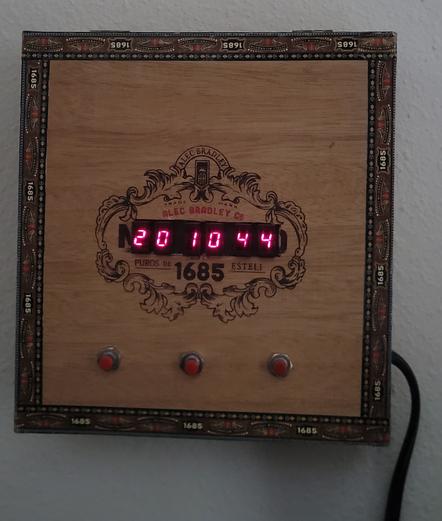 Cigar box that has old style glowing digits
