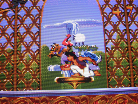 Aladdin admires some colorful statuettes in the Sultan's palace, unaware that such opulence requires an exploited labor class.