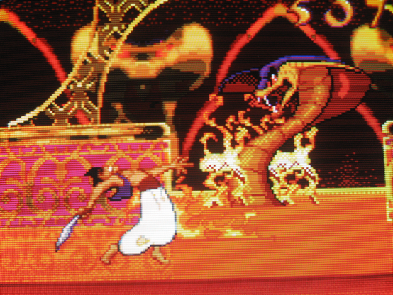 The evil wizard Jafar, who has transformed into a giant cobra after successfully executing a military coup and establishing minoritarian rule, absolutely roasts Aladdin with magic fire.