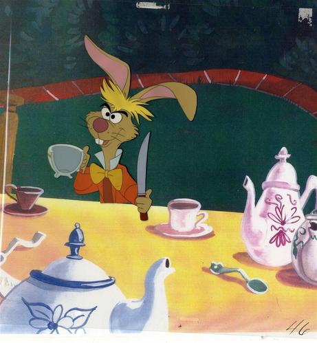 photo of the March Hare holding half a tea cup, sliced vertically, and the knife he used to cut it