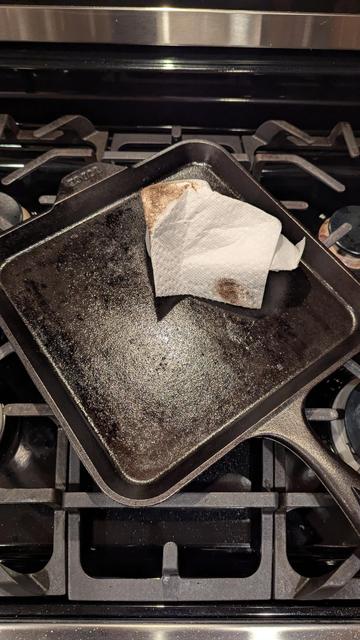 My cast iron pan on the stove, showing how oily it is.