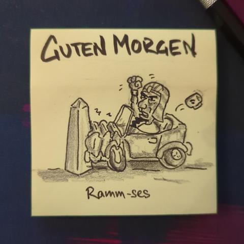 Auf einer gelben Haftnotiz steht "guten morgen "
Darunter ist ein Pharao zu sehen, der sein auto gegen einen Obelisk gefahren hat und wütend die Faust erhoben hat.
Es ist Ramm-ses