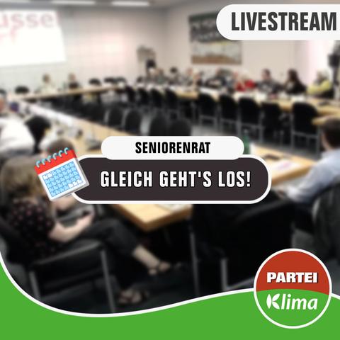 Zu sehen ist eine unscharfe Totale des Sitzungssaals im Düsseldorfer Rathaus. Viele Menschen sitzen an Tischen zusammen, die gemeinsam ein Rechteck bilden. In der Mitte des Bildes steht "Seniorenrat" in einem weißen abgerundeten Kästchen. Darunter steht in einem anthrazitfarbenen abgerundeten Kästchen "Gleich geht's los!". Am unteren Ende des Bildes fließt unsere grüne Wandelwelle und das Die PARTEI-Klima-Fraktionslogo.