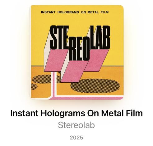 Cover of the Stereolab album, titled Instant Holograms On Metal Film.
The cover is mostly yellow, featuring the Stereolab name prominently in the middle, in black letters with a pink 3D effect.