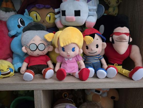 the same plushies of the mother 1 protagonists but unboxed, in my plushie shelf, along with some other, unrelated plushies