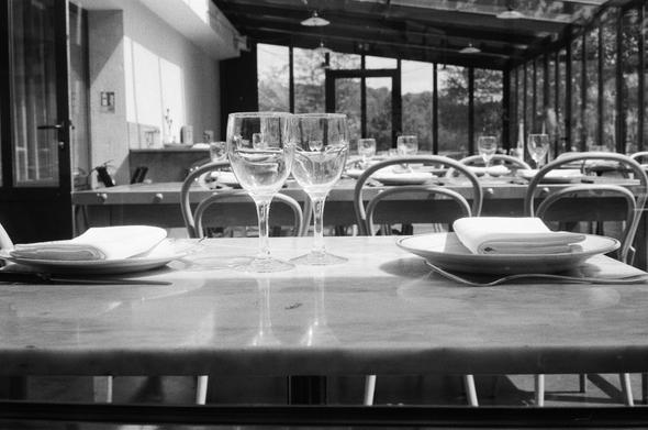 A table set in nice light with glasses, plates, etc