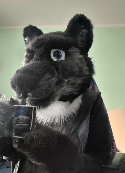 Rawen, sitting at his desk while taking a sniff of freshly made cup of coffee.