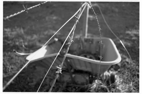 A wheelbarrow and some barbed wire