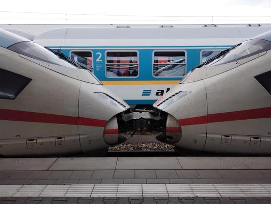 Two Deutsche Bahn ICEs perform a licentious coupling ritual in front of a suitably shocked Alex train in Munich HBF.