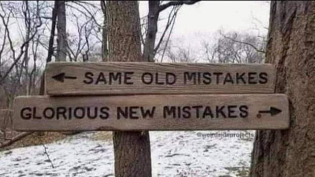 wooden signs in a woods. One points left and says: same old mistakes. The other right and says: glorious new mistakes