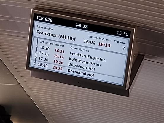 Information display on board ICE 626 showing an eleven minute delay into Frankfurt Airport, and a two-hour delay into Köln, the next station.