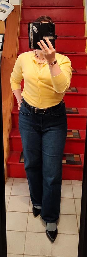 Yellow cardigan tucked into wide leg jeans. Black belt, black pointy toe flats. Black and white very thinly striped socks. Stacked necklaces: citrine and vintage Czech glass. Bangle bracelets.
