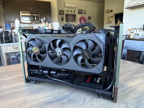 Side profile of the other side of my PC with the side panel off. The triple fan graphics card is slotted in vertically, either a decent making of space leftover underneath and to the right of it. There is an SSD moistness underneath it.