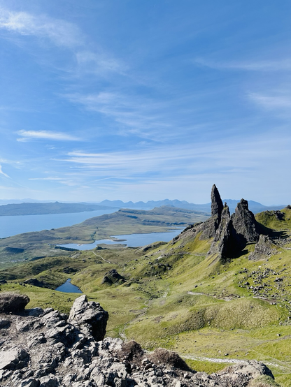 The Trotternish Ridge (highest summit being The Storr at 719m) was created around 60million years ago by a massive landslip. Hot volcanic lava flowed onto the weaker sedimentary Jurassic rock beneath it causing the latter to collapse and form the undulating cliff faces of the eastern coastline of Trotternish. The magnificent pinnacles and weathered basalt rock formations of The Storr dominates the Island’s north-eastern landscape and can be seen for miles by travellers heading north as well as from the mainland. It is one of the most photographed landscapes in Scotland. The rocky peak dominates the area and its summit is a touchpoint along The Skye Trail, a popular walking route that can take anything from 5-10 days by foot. The ‘Old Man’ stands in front of the Storr and is scarcely visible from down on the main road. The walk up to it is steep but fairly short. This view from the highest lookout point is the reward. The Cuillin Hils are in the distance..