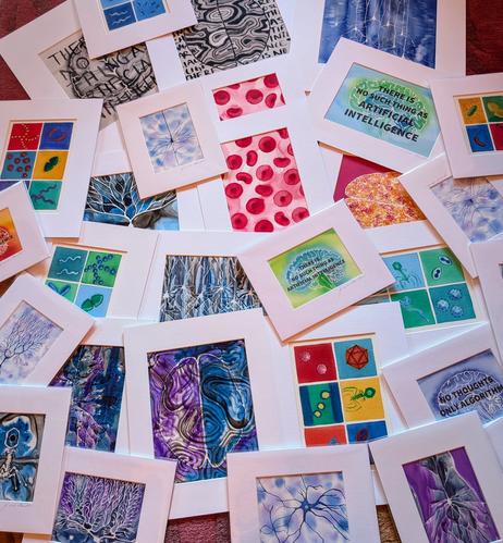 Big pile of ink and watercolor paintings on the floor