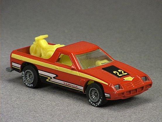 Released in 1984, Red Dodge Rampage of 1984 Hot Wheels with Real Riders wheels. Notes: Concept model of a Camino style Dodge truck with 3-wheel ATV in the truck bed. Tampo: Yellow, black and white stripe with 'Rampage' on sides '2.2' on hood. Packaging: 1984 Blister. Metal Body, Metal Base. Made in Malaysia. Scarcity: 5/10