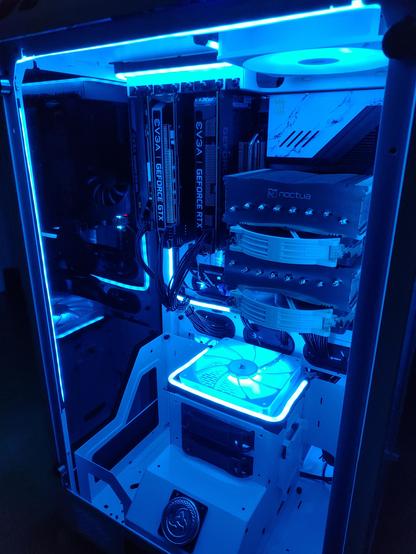 A dark room photo of my new PC build Odin showing off the ARGB lights and what parts are inside my new PC.