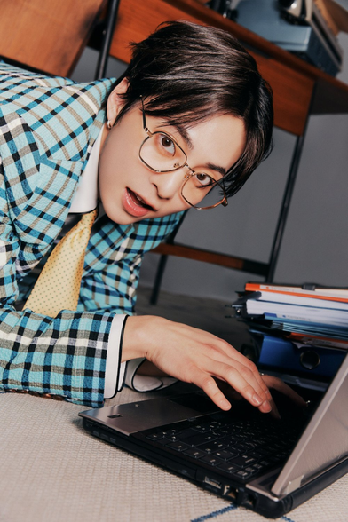 Xiumin in plaid, with a laptop being adorbs