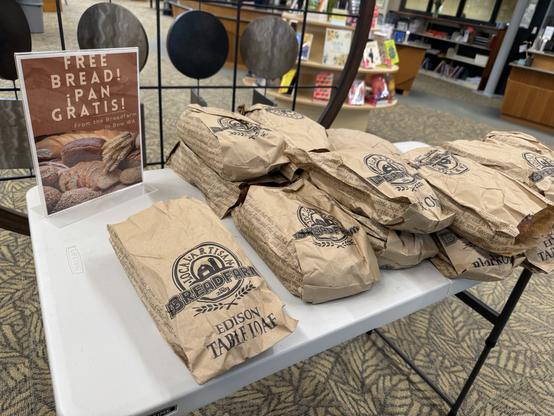 A nearly full table of Free bread! at the Burlington library, courtesy of Breadfarm.