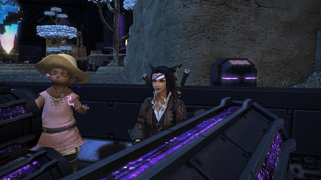 How best to describe this FFXIV screenshot? A male Lalafell, dressed in the same pink tunic as a female Miqo'te he follows around...has one hand placed on a giant battery which has been literally charged with lightning. He is being zapped by purple zaps... but his expression might be pain...pleasure...or both. And it's probably best we don't ask.