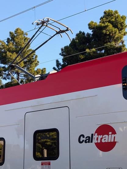 A Caltrain electric-multiple-unit train showing its pantograph touching the overhead wires in Mountain View on a morning in May of 2025.