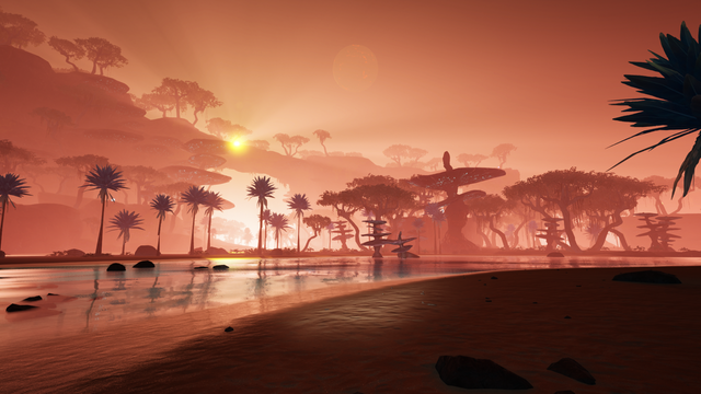 A sunrise makes the tropical beach landscape glow in a golden pink light.