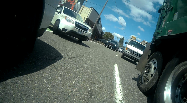 white subaru blocking the bike lane