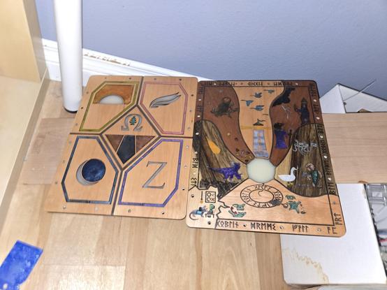 Oiled wooden book covers with elaborate designs drying next to bunny damaged moulding