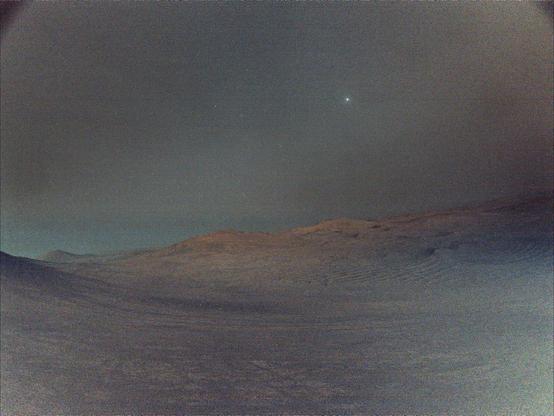 Deimos seen above the martian horizon.