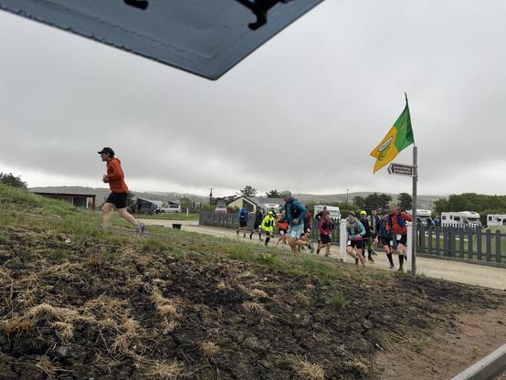 Runners of Sliabh Liagh Adventure Race after start. Picture taken from inside a campervan. Sky is grey and it is raining.