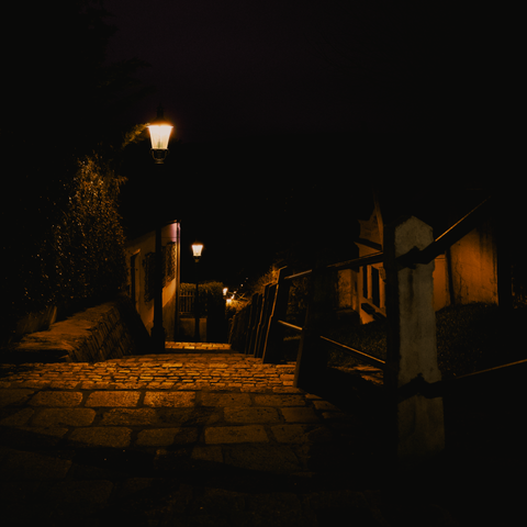 dimly lit downwards stairs at night