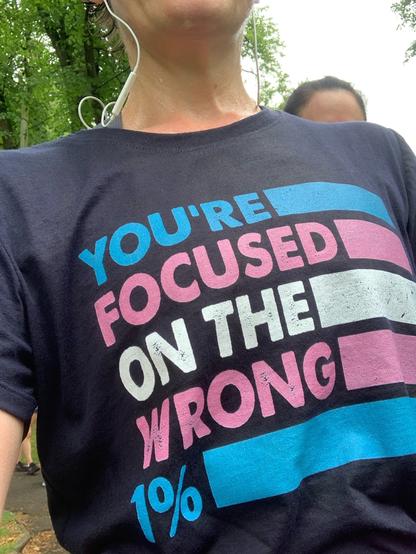 A t shirt which says "you're focused on the wrong 1%" in trans colours