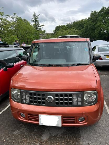 An orange Nissan Cube Z11