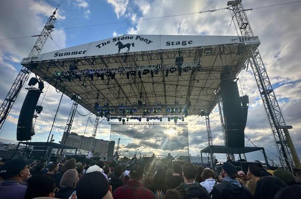 Joe Russo’s Almost Dead performing at the Stone Pony Summer Stage in Asbury Park NJ on Friday May 23, 2025. Daytime shot of the band on stage with the sun breaking through the clouds behind the stage.