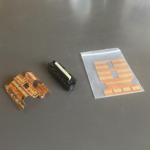 HP-41 battery plus module block restoration. Old, worn and gooped up flexible strip on left. New adhesive one on right will wrap around block in the middle.