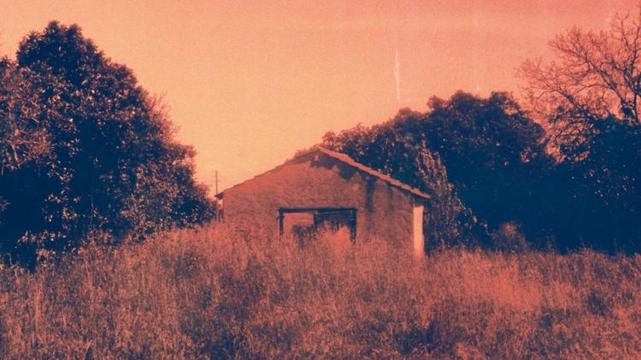An abandoned building in a field. Taken with a Zorki-6 using Harman Red film.