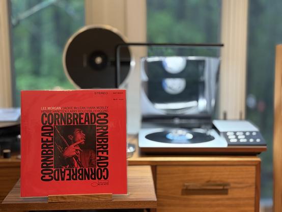 Lee Morgan - Cornbread LP cover.

On a red background, a black and white photo of Lee holding his trumpet, surrounded by the word "Cornbread". Artist names above.

The black LP plays on a vintage, restored Bang & Olufsen Beogram 8002 linear-tracking turntable to the right.