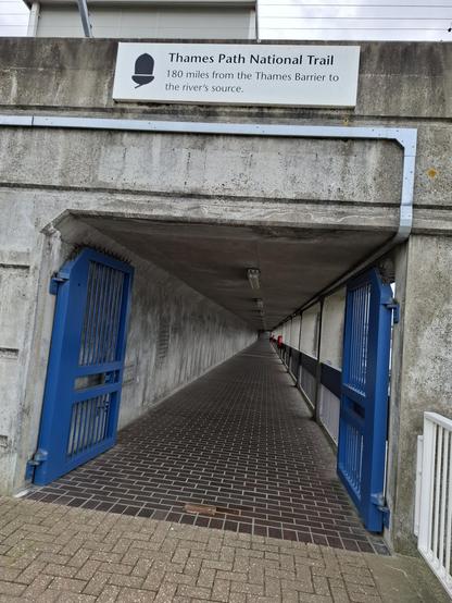 An underpass marks the end/start of the Thames Path. A notice above says 180 miles to the source