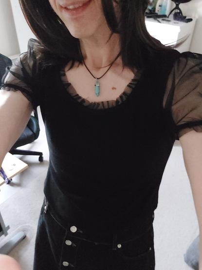 Non binary person in a black top