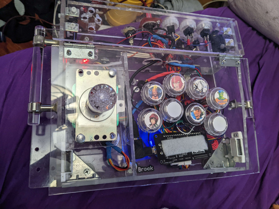 Top view photo of an arcade style Fight stick, made from clear acrylic save the wires, buttons, and PCB