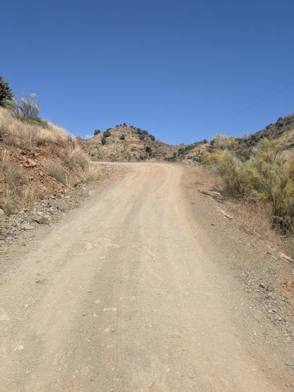 a gravel road twisting and climbing a hill. Very dry.