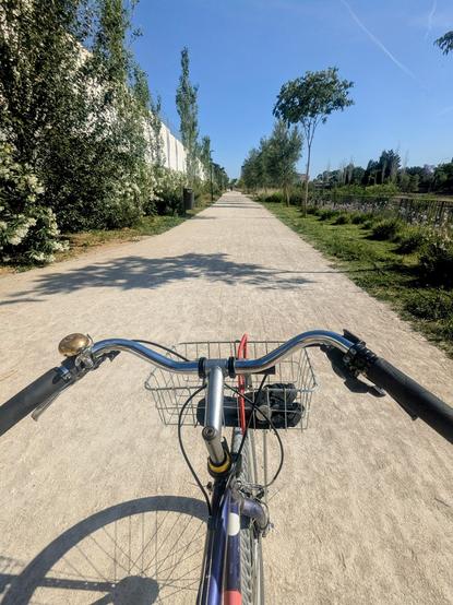 pov from  bicycle with city handlebars on a gravel multi user path.